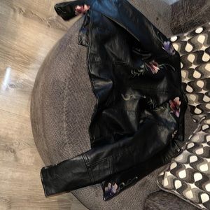 Leather Jacket, Black with a flower pattern has reds/pinks purples and green